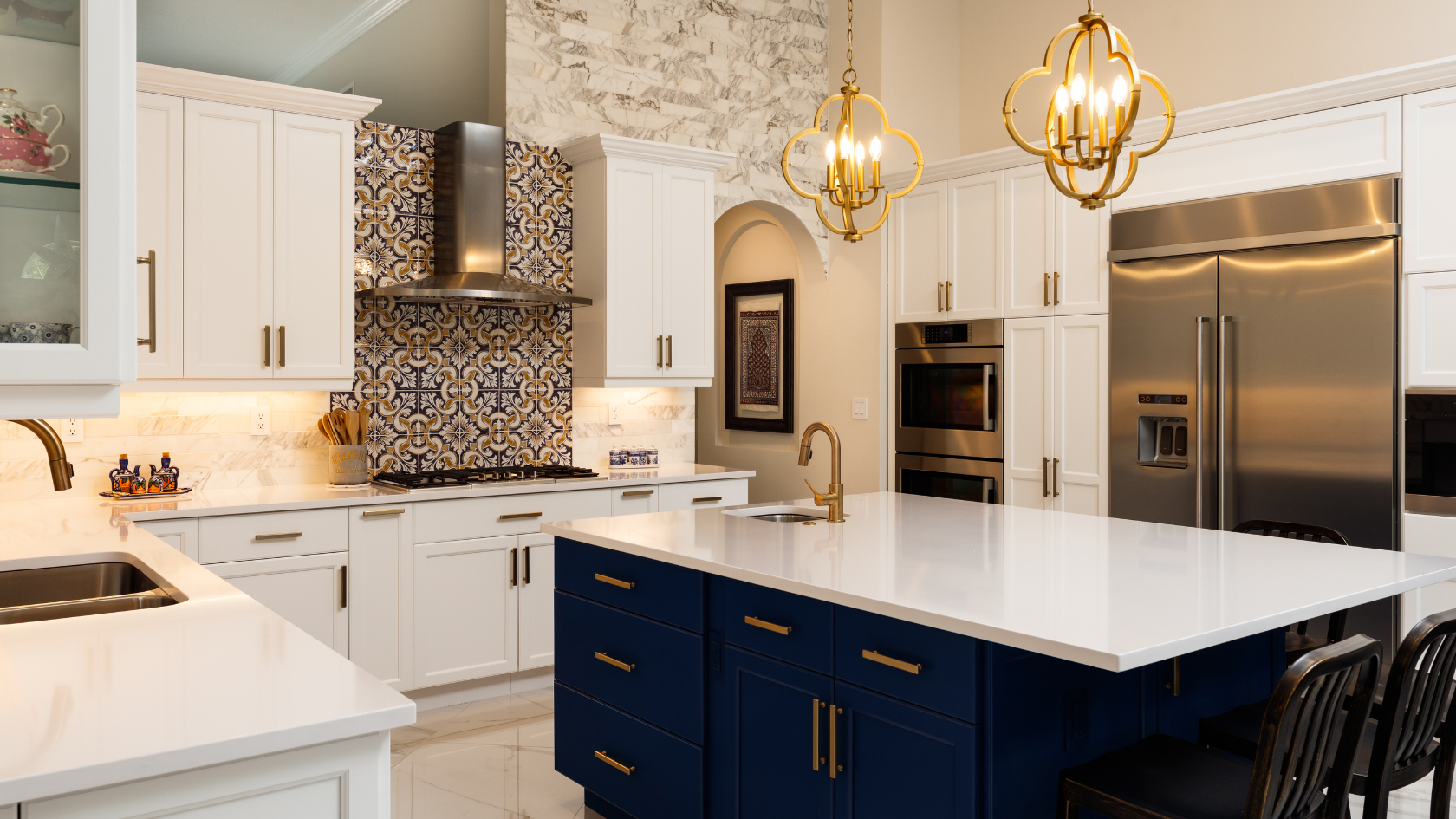 A kitchen with white cabinets and a blue island